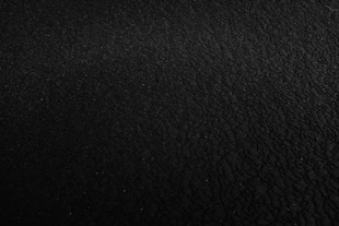 a black and white photo of a black surface