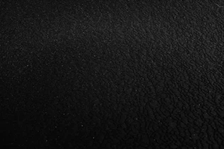 a black and white photo of a black surface