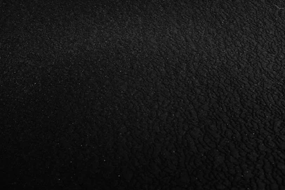 a black and white photo of a black surface