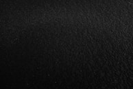 a black and white photo of a black surface
