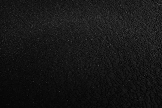 a black and white photo of a black surface