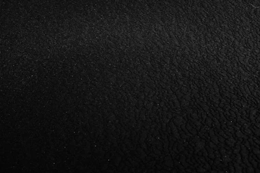 a black and white photo of a black surface