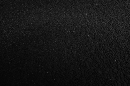 a black and white photo of a black surface