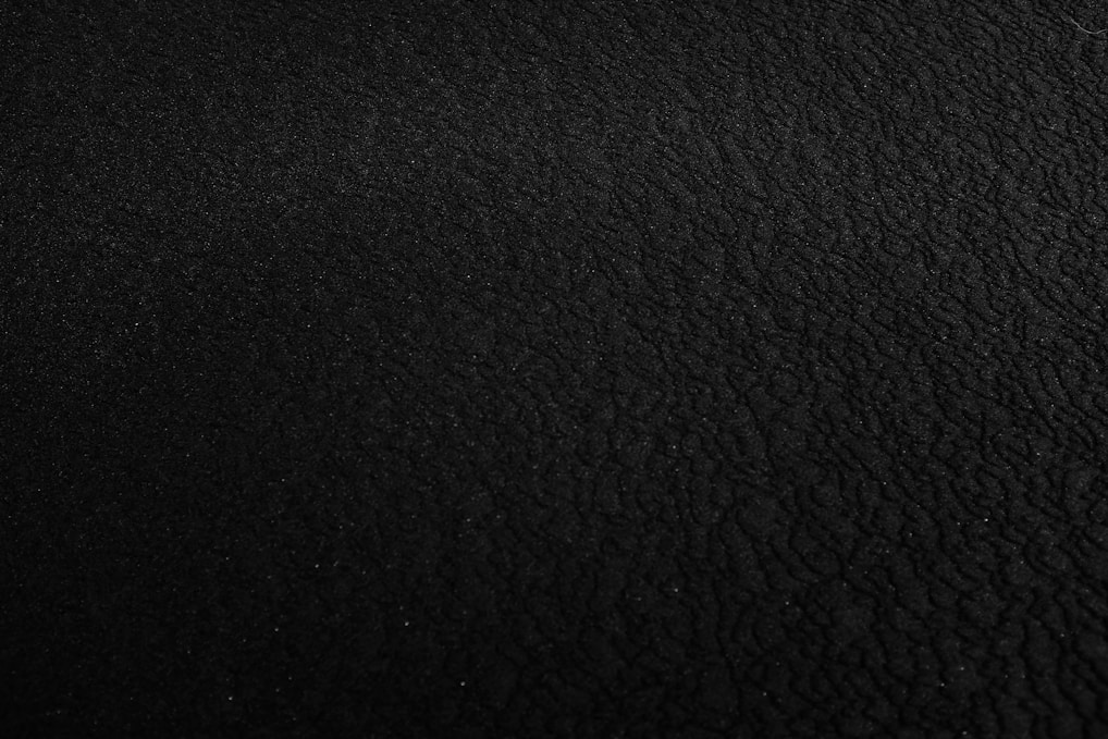 a black and white photo of a black surface