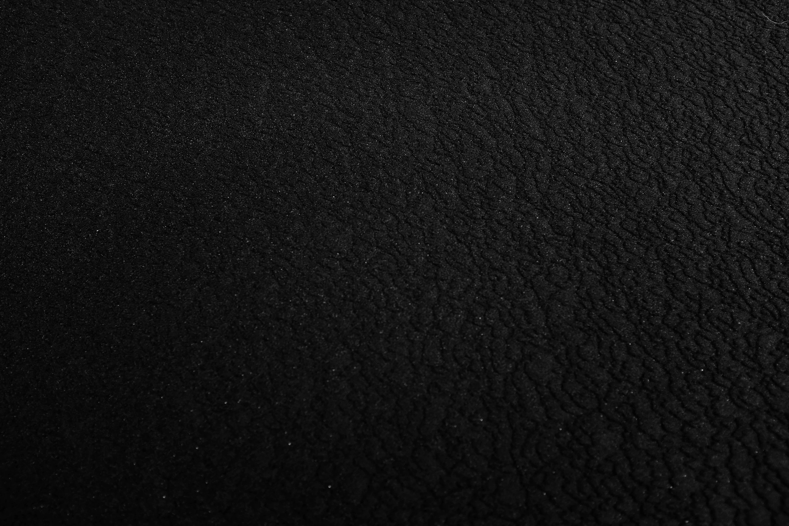 Close-up of a black pebble-grain texture