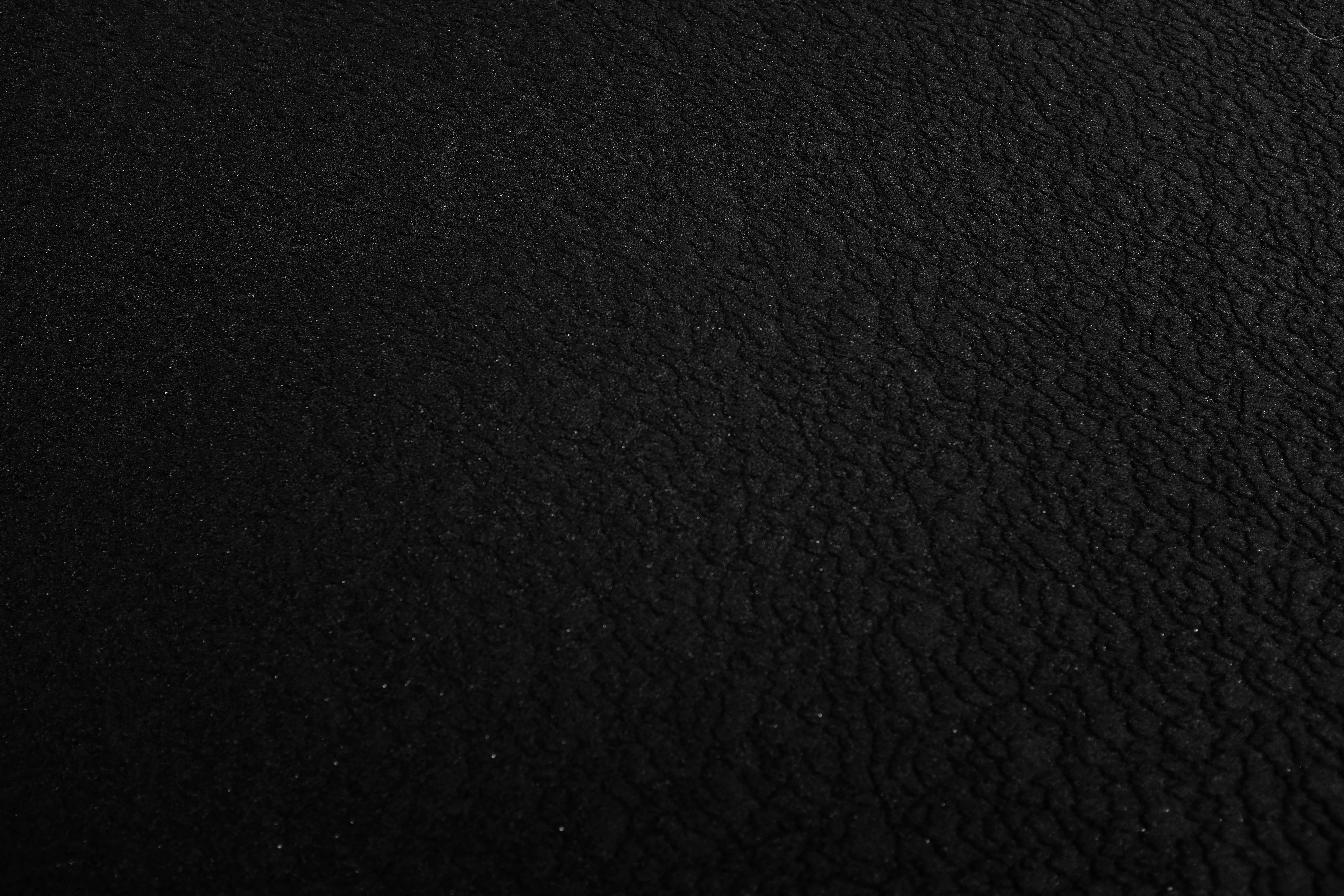 a black and white photo of a black surface