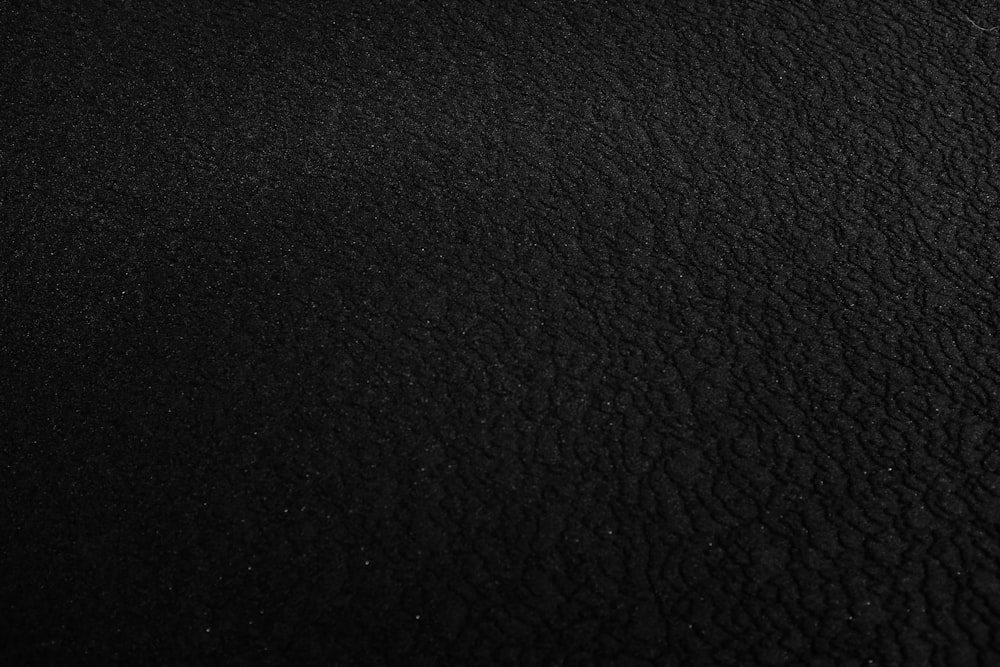 a black and white photo of a black surface