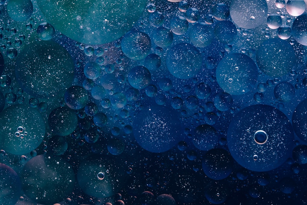 a close up of water bubbles on a blue surface