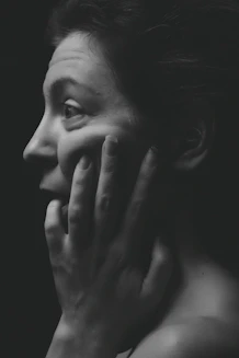 woman face palming grayscale photography