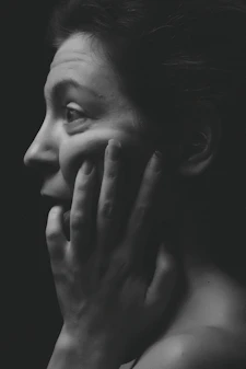 woman face palming grayscale photography