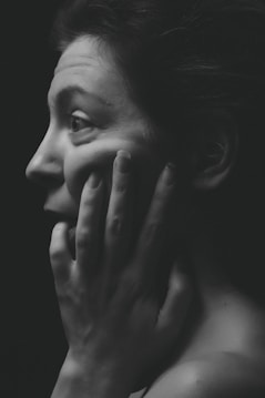 woman face palming grayscale photography
