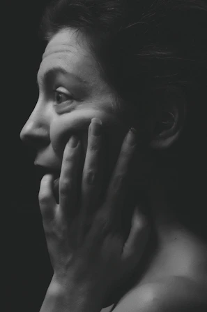 woman face palming grayscale photography