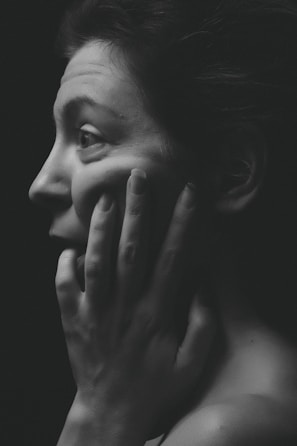 woman face palming grayscale photography