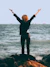 woman standing on shore near sea