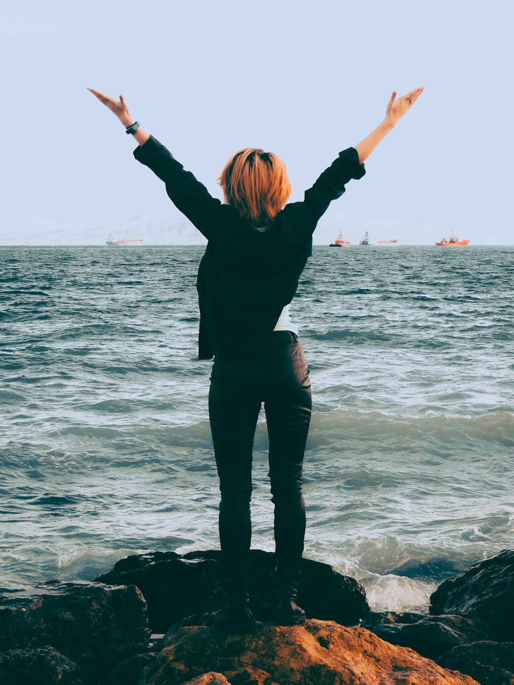 woman standing on shore near sea