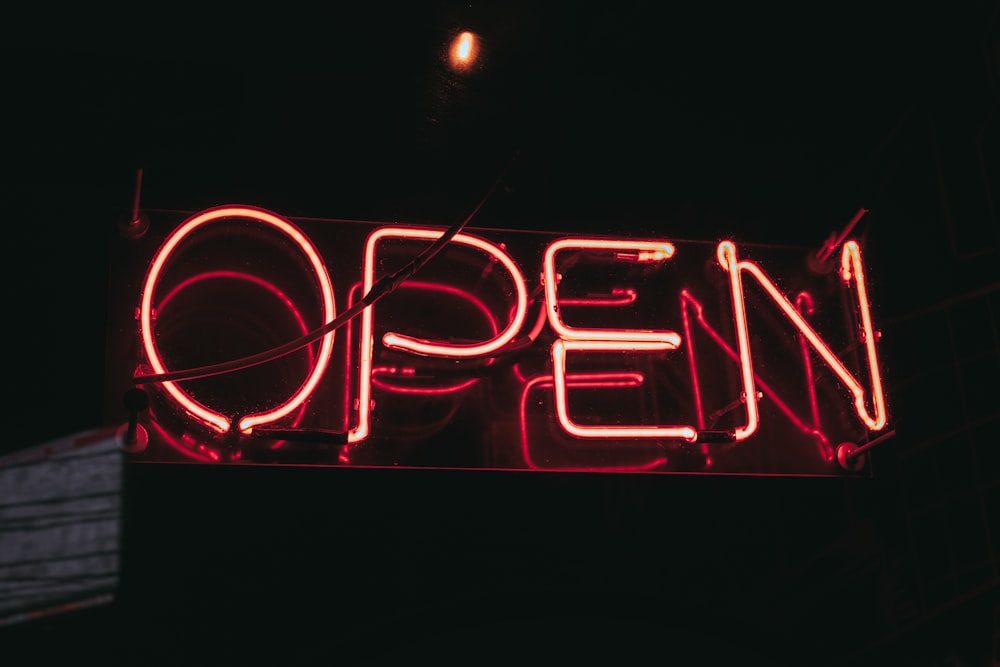 turned-on red open neon signage