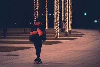 Model wearing a sleek fleece jacket walking through an urban skate park at sunset