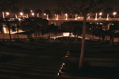 Community gathering at the landscaped open-air amphitheater with soft lighting.