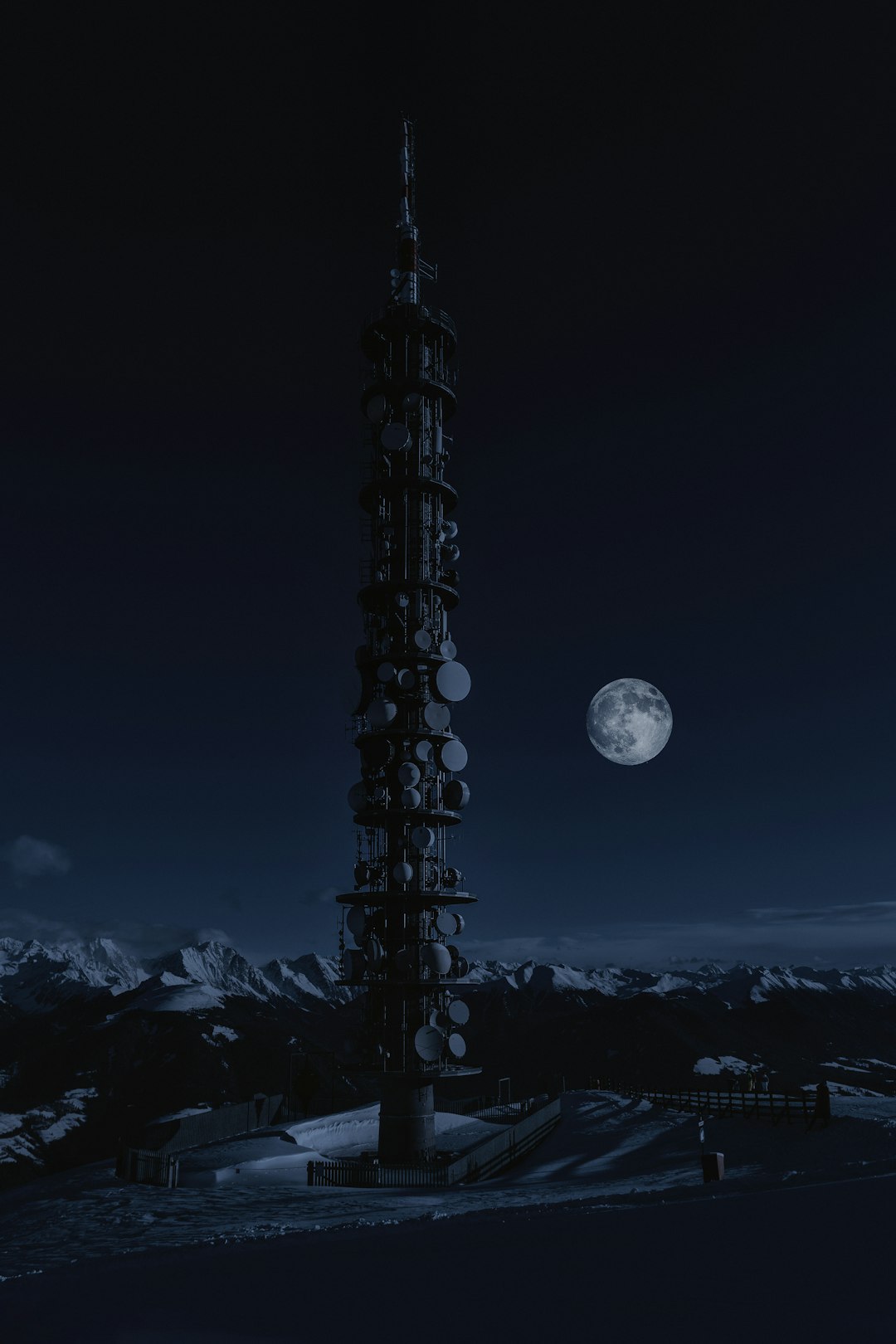 tower on snow under full moon