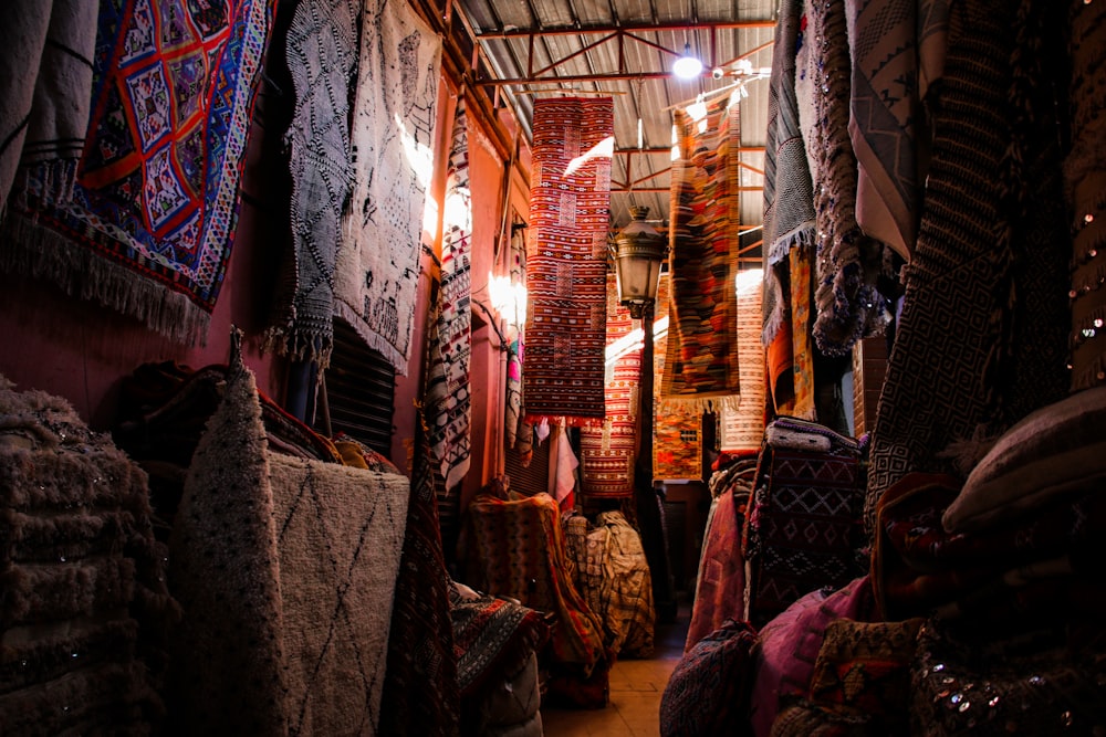 a room filled with lots of rugs and blankets