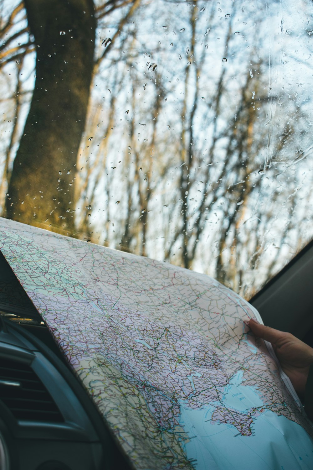 person holding map inside vehicle