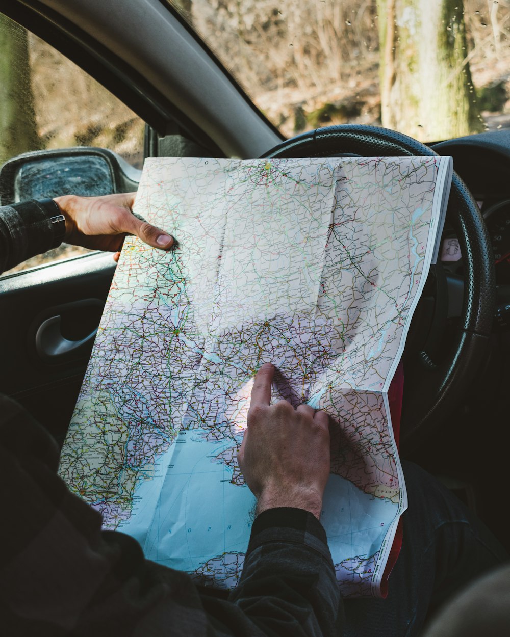 person holding map in vehicle\