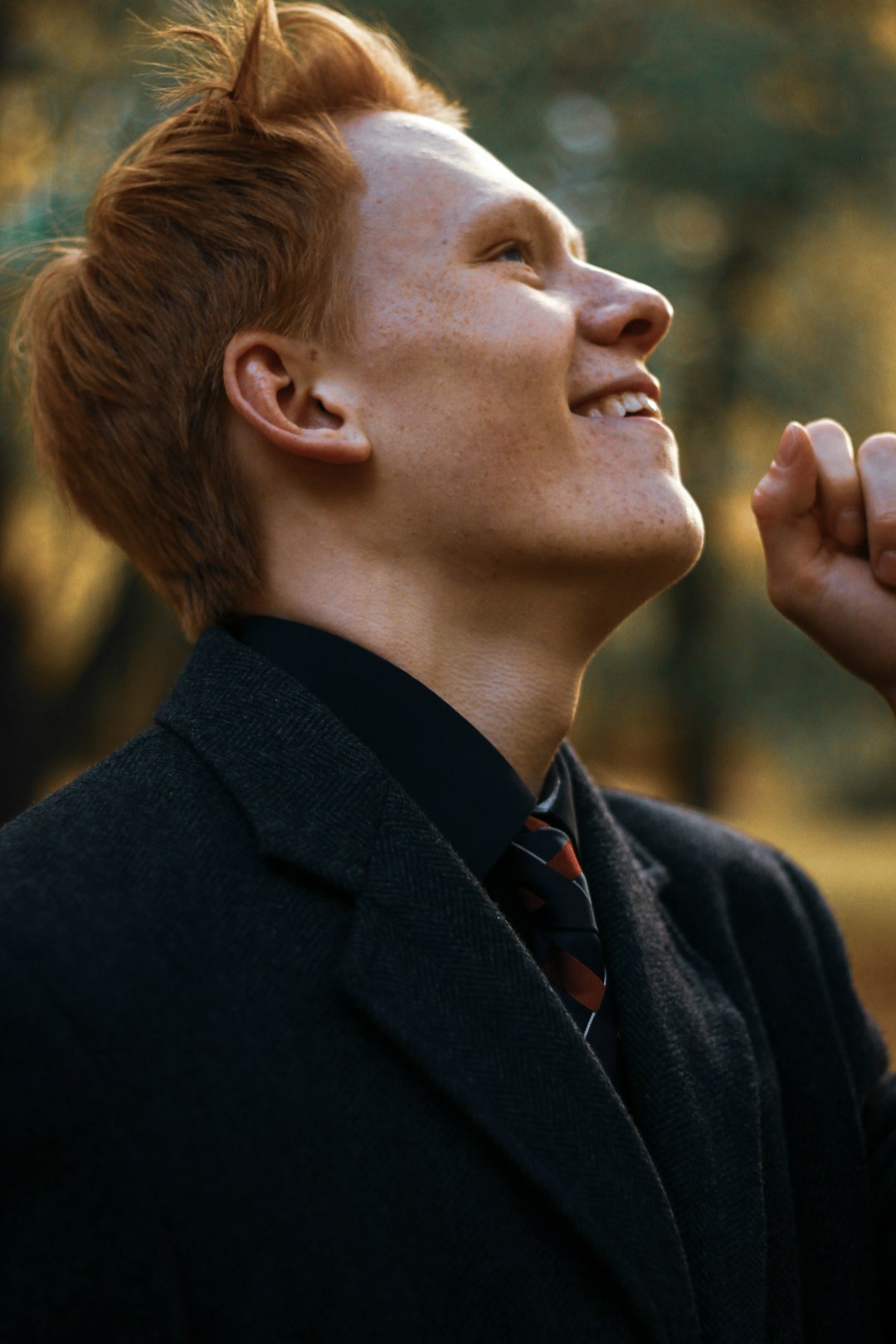 smiling man wearing black blazer