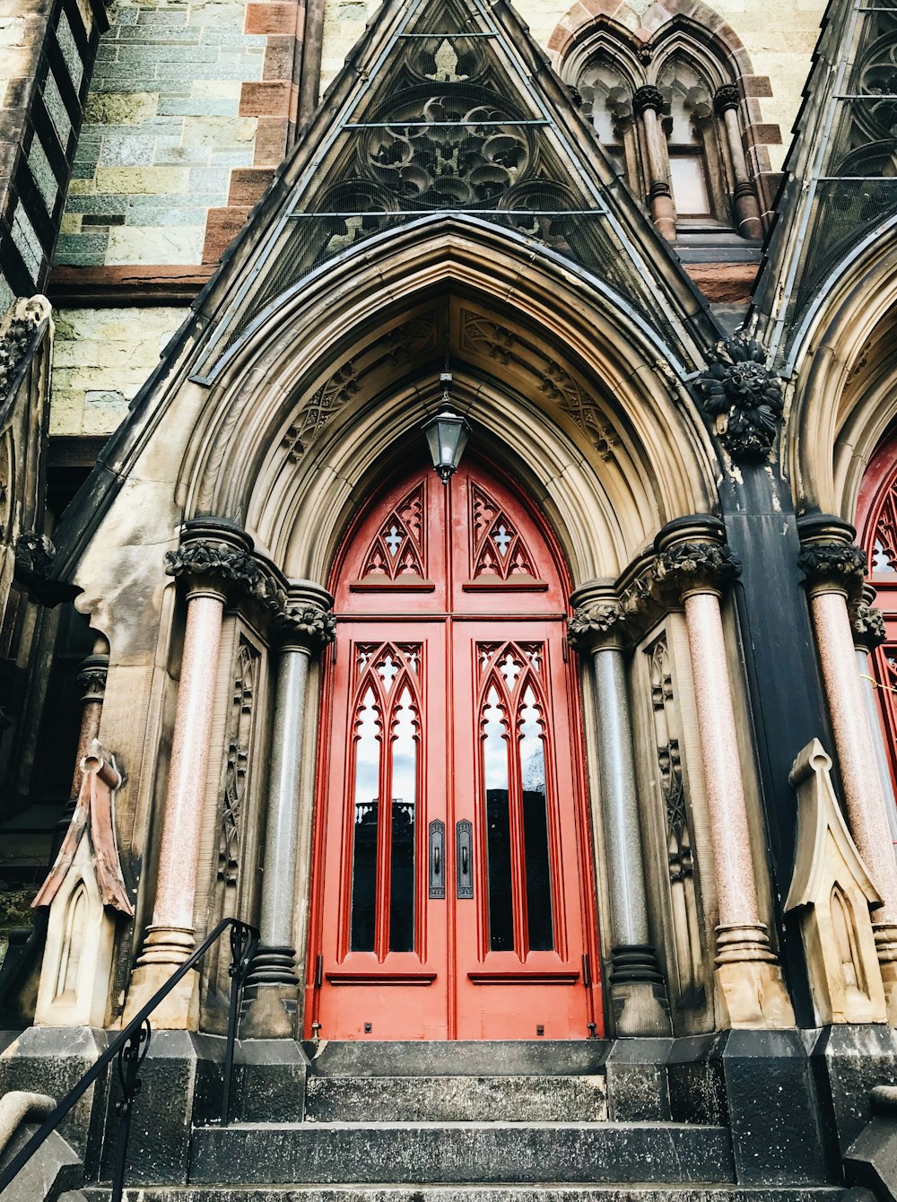 a red door is on the side of a building