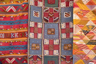 three assorted-color quilts