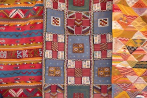 three assorted-color quilts