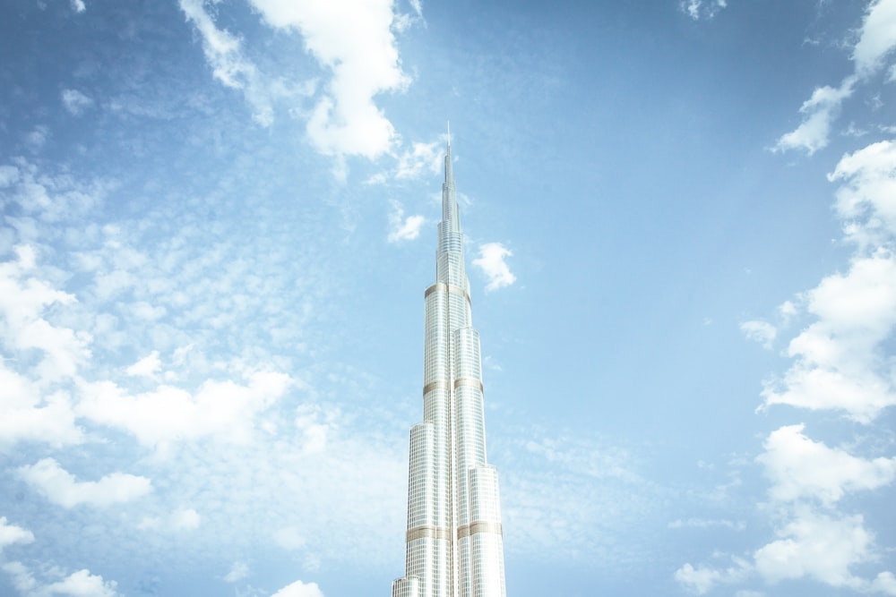 a tall white building with a sky background