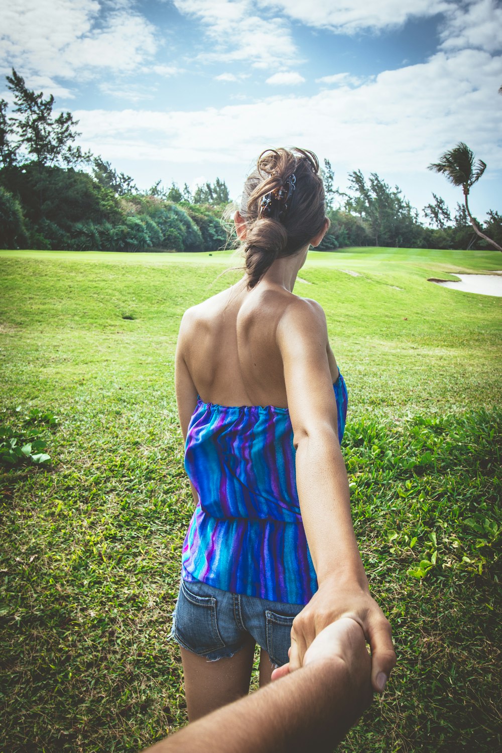 woman wearing blue and purple strip strapless top and blue short shorts during daytime