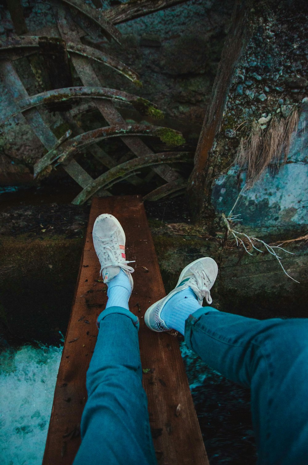 person in white shoes on wood