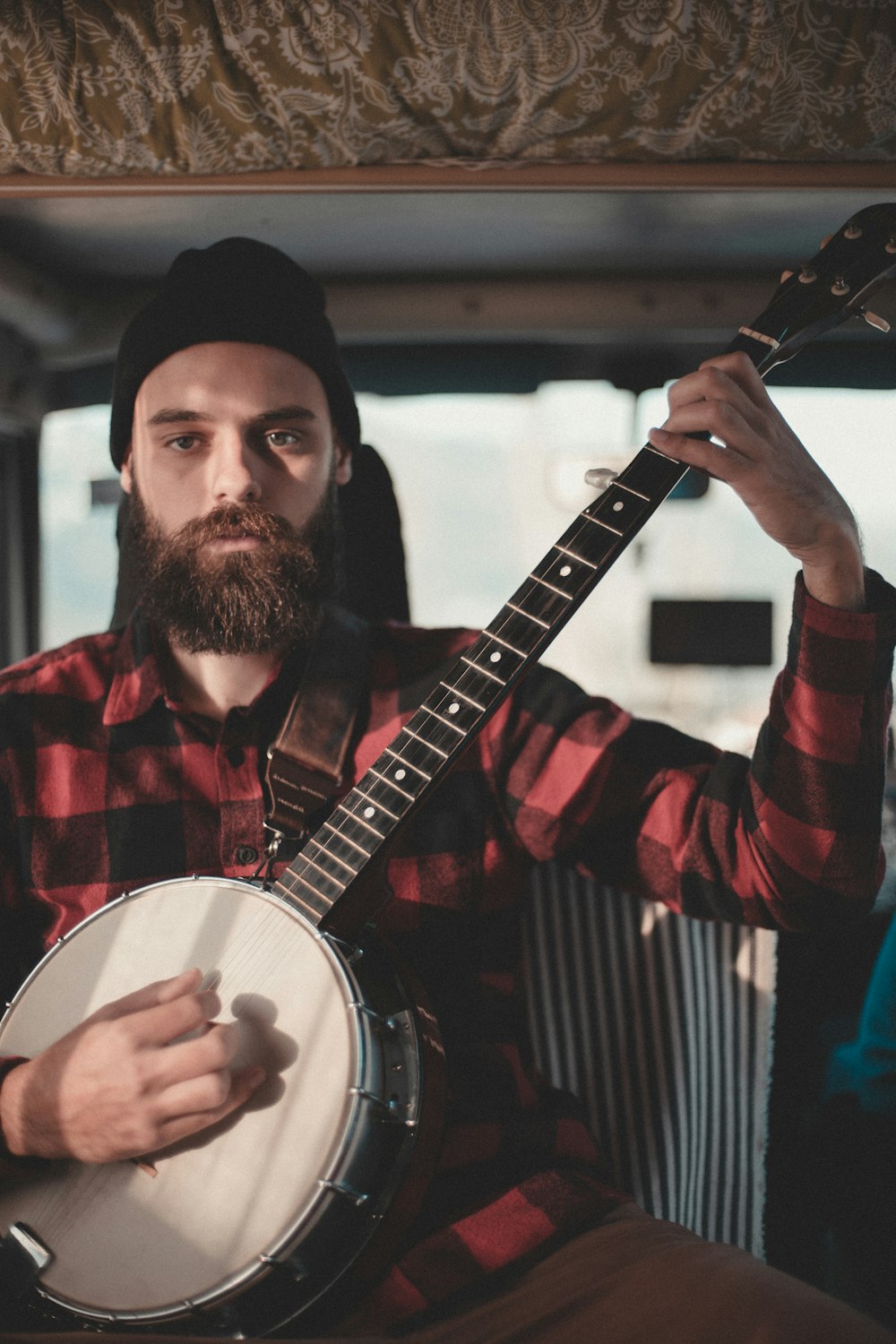 man holding string instrument