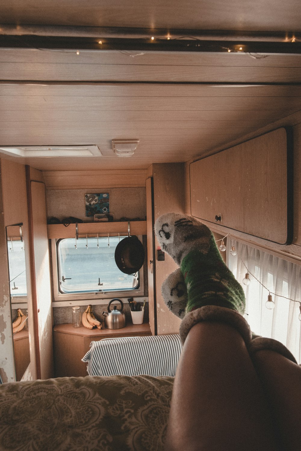 person in green-and-white cat socks in trailer