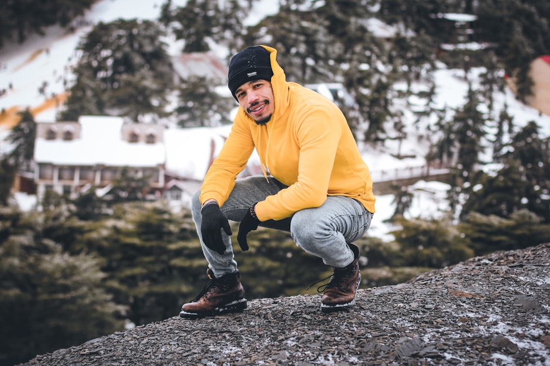 smiling man sitting front of building