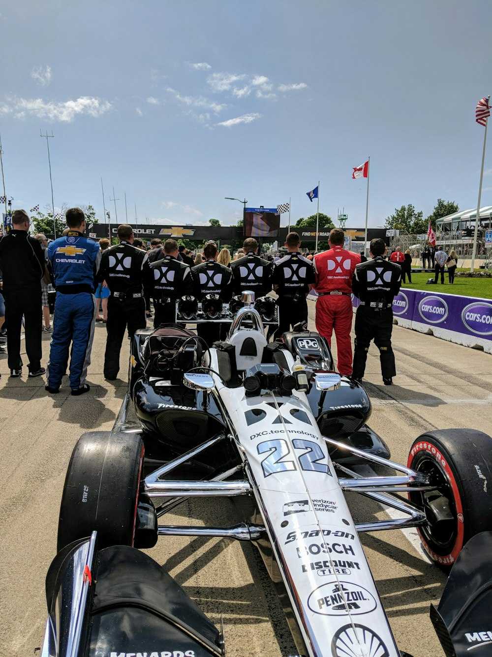 men standing behind racing cart