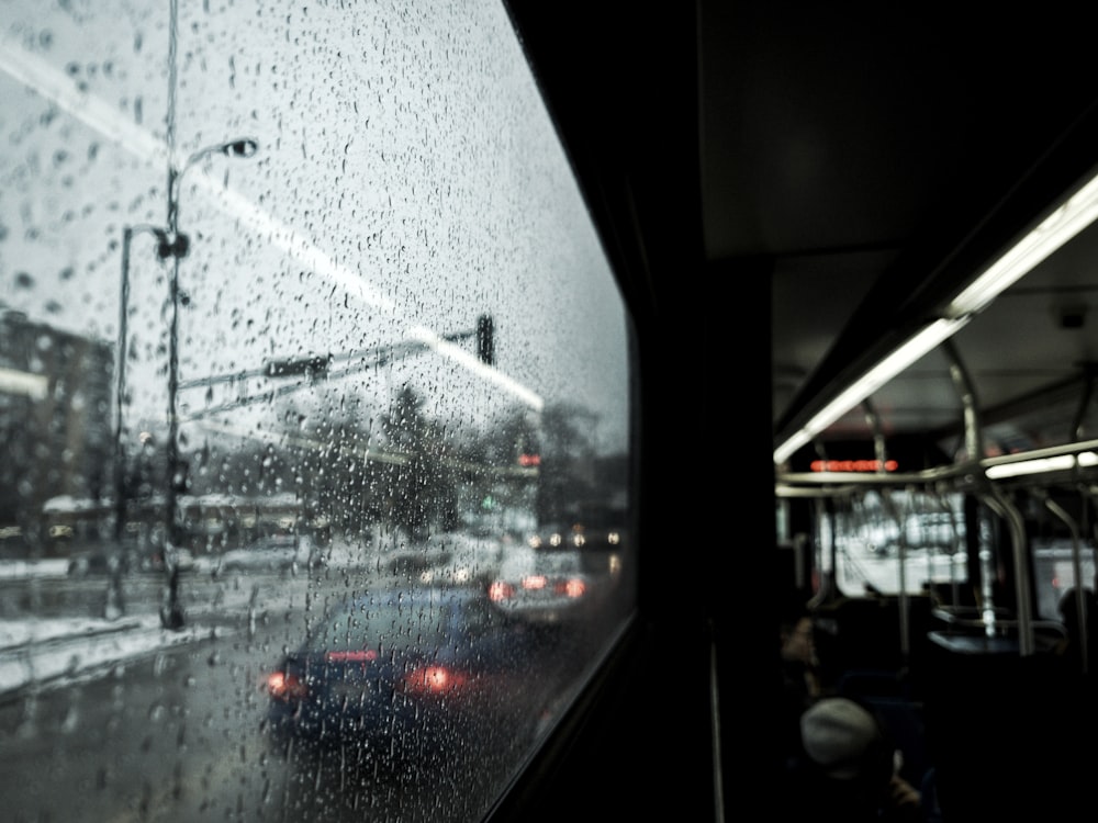 a view of a city street through a rainy window