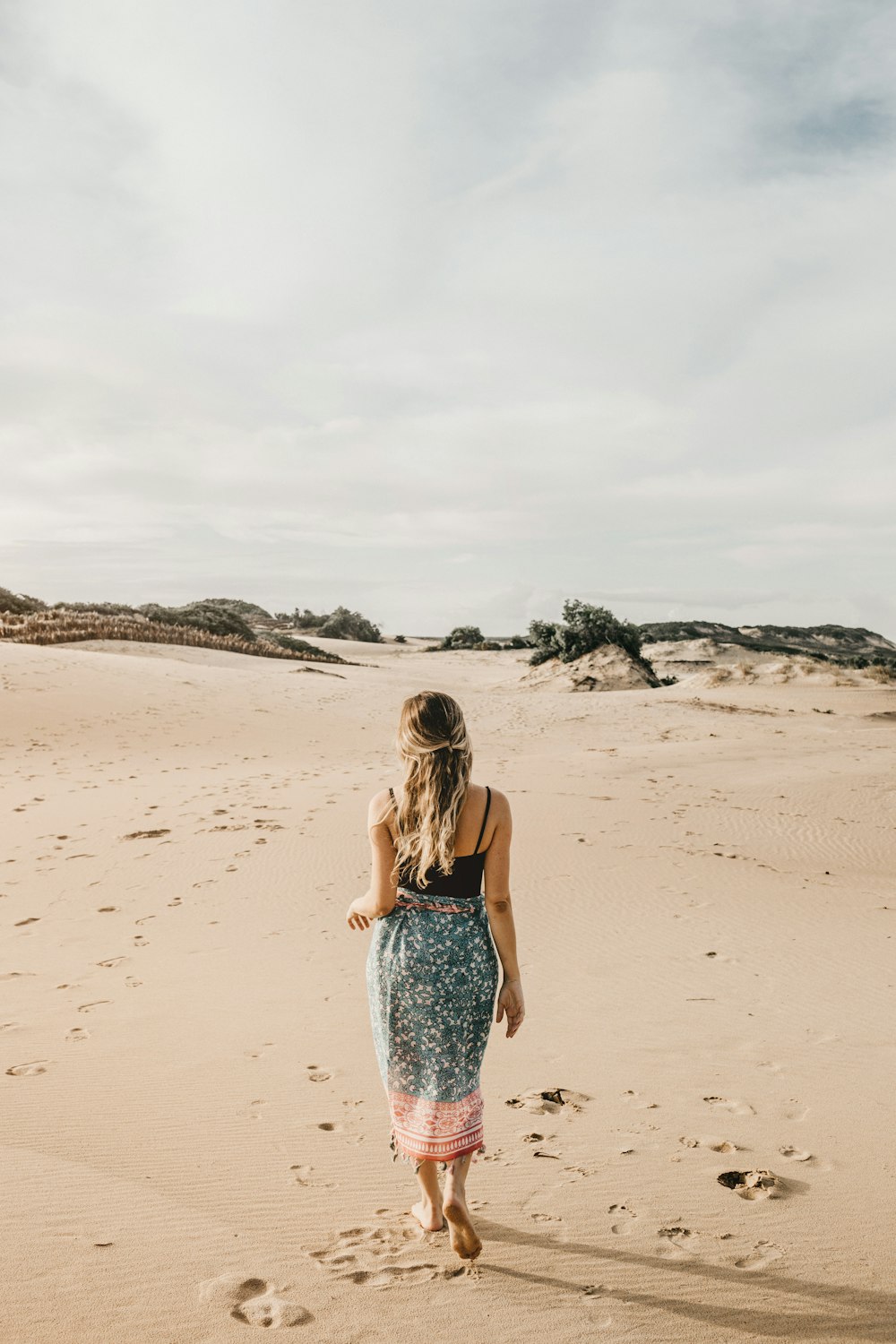 man woman standing on shore at daytime