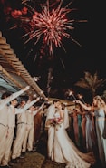 man and woman wedding couple kissing under fireworks