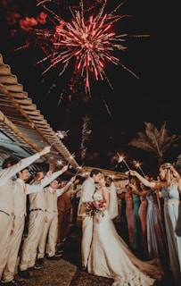 man and woman wedding couple kissing under fireworks