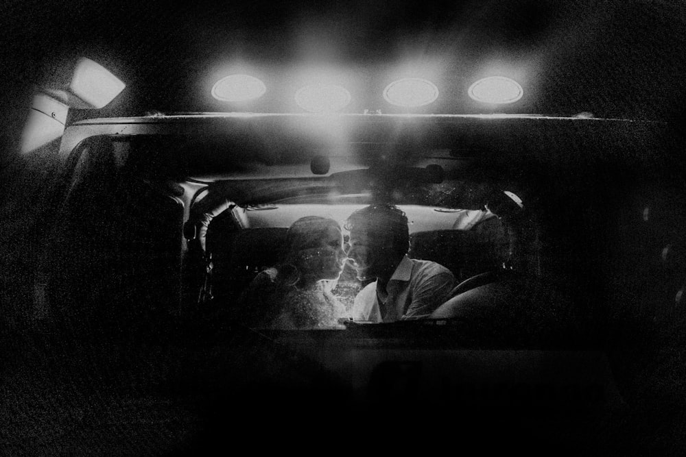 lighted kissing couple inside car