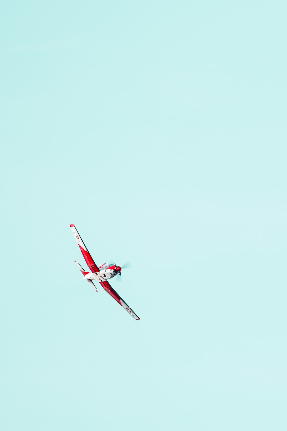 flying red and white biplane