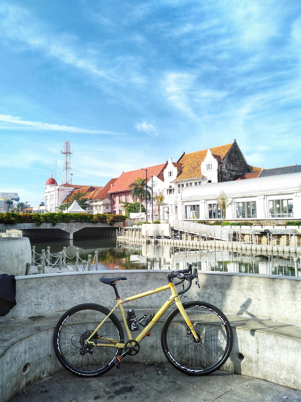 yellow road bike parked on concrete bench