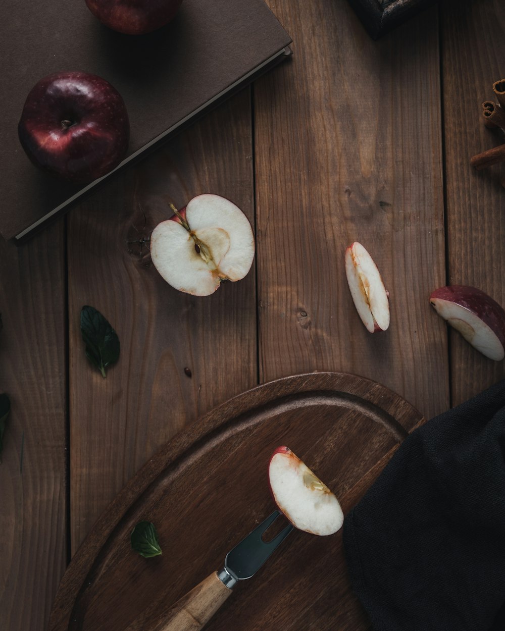 sliced apple fruit beside cutting board