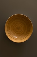 A minimalist wooden bowl with a smooth finish.