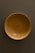Close-up photo of a beautifully hand-turned wooden bowl with rich grain patterns.