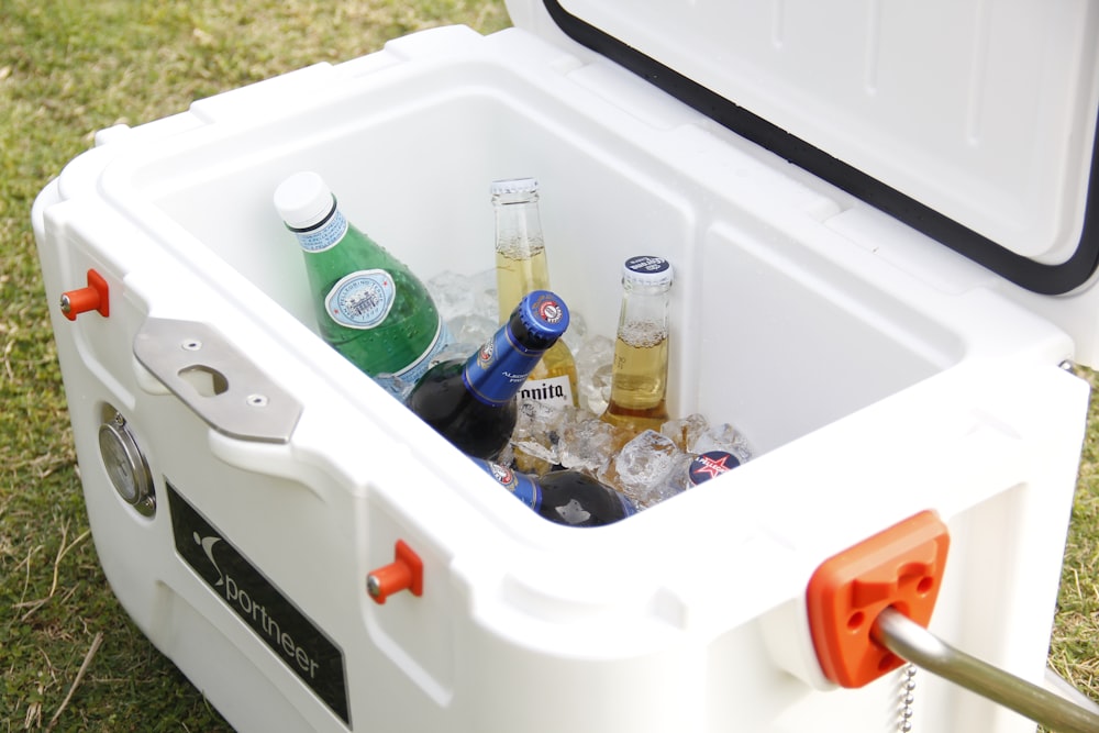 white ice cooler with assorted-brand bottle lot