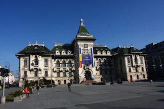 Historic monument in Bucharest surrounded by green parks on a sunny day