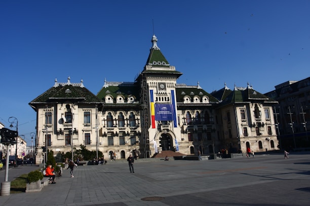 A panoramic view of the Palace of Culture in Iași under a bright sky.
